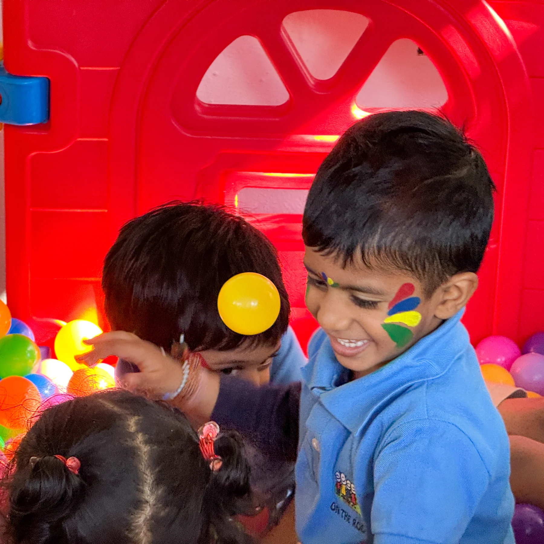 Two children playing together in the play area
