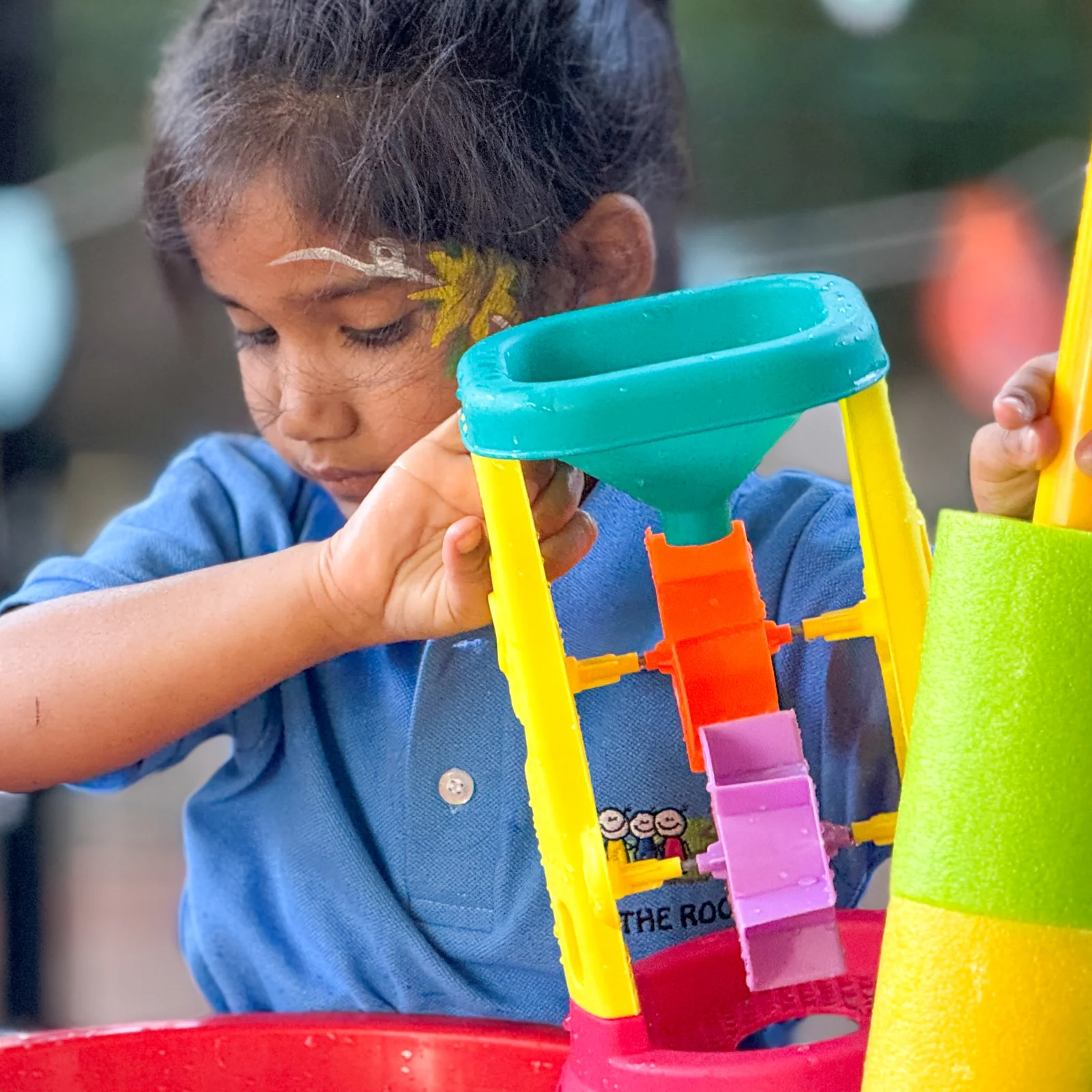A child exploring a water toy